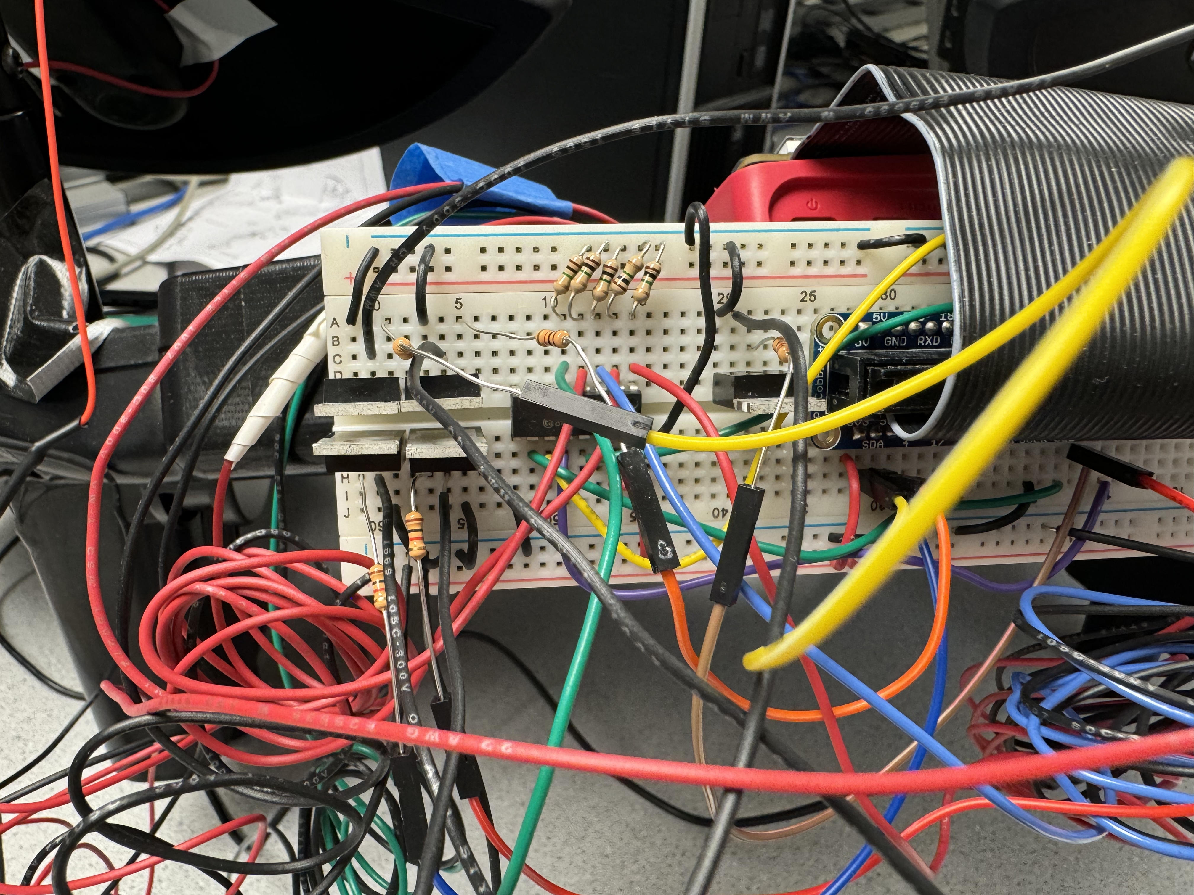 Inside of drum pad chassis with colored wires going from sensors to a hole in the middle