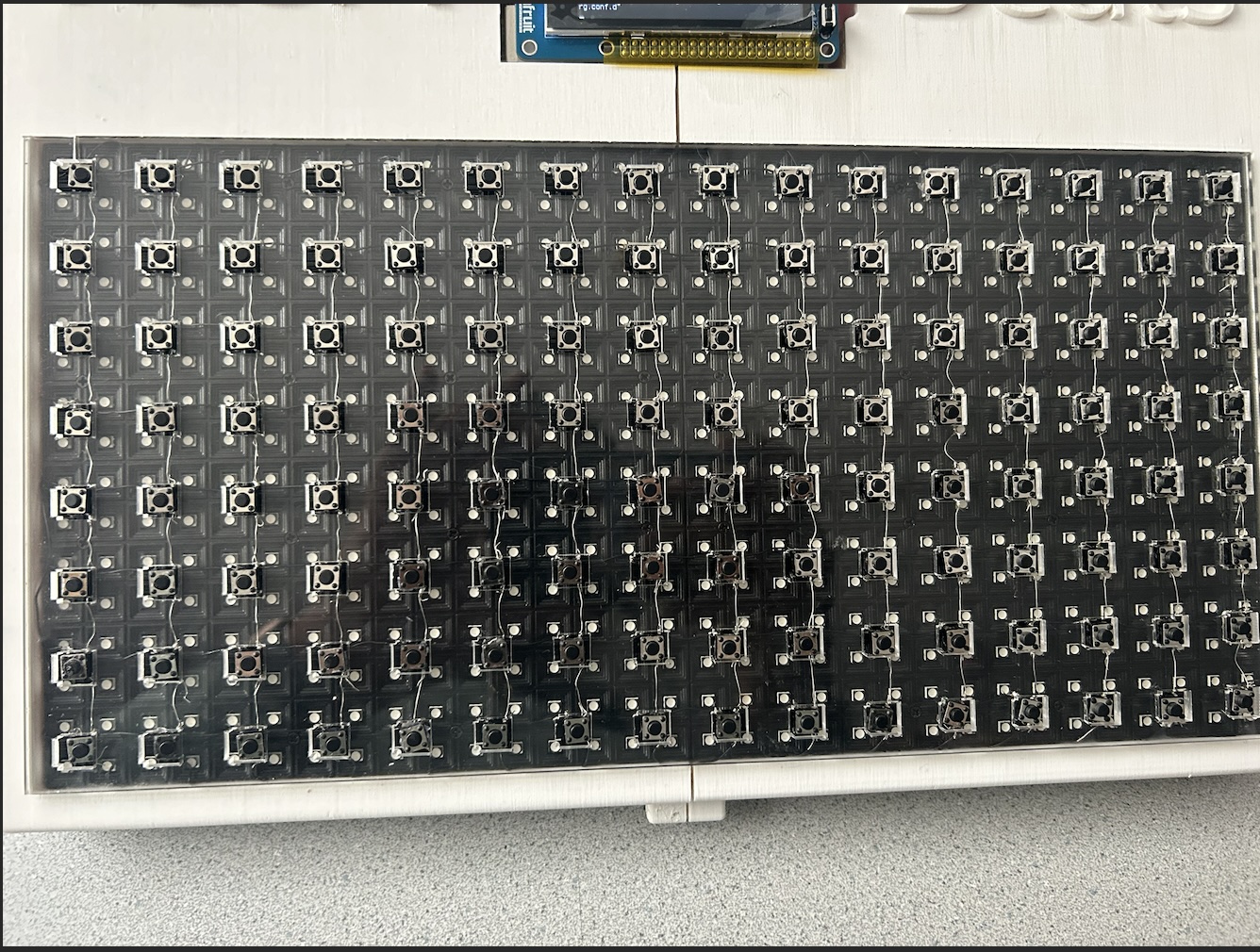 (B) shows the button matrix and the wires connecting them.